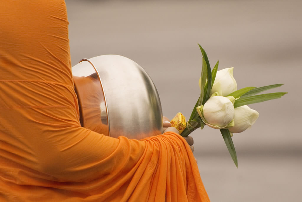 monk-holding-flowers Cocnuts-and-monkeys-Paradise-Koh-Yao-near-Phuket-Thailand